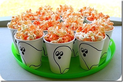 White cups with ghosts drawn on them to make fun popcorn tubs for Halloween