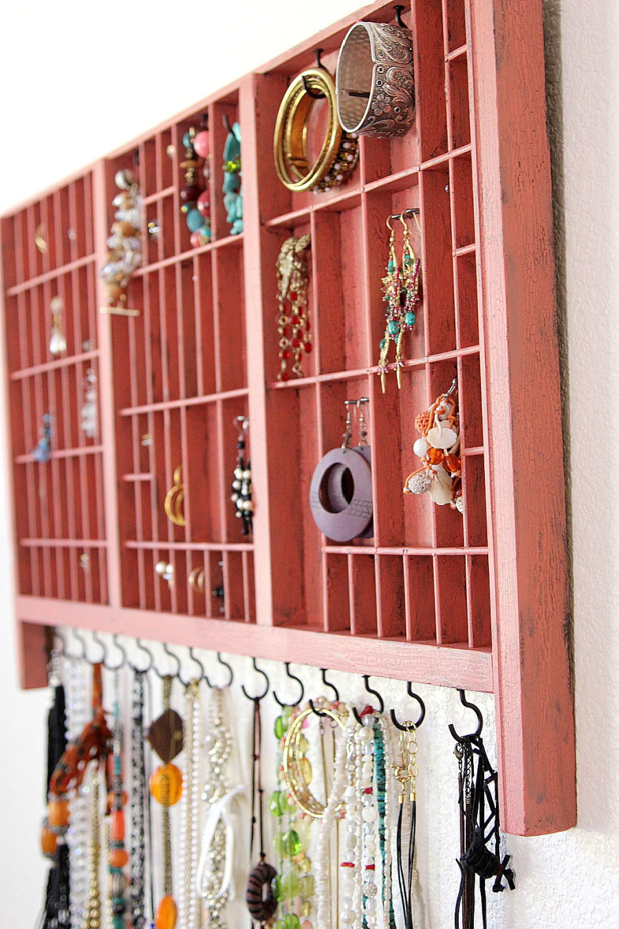 DIY wall jewelry organizer from a printer's typeset drawer.