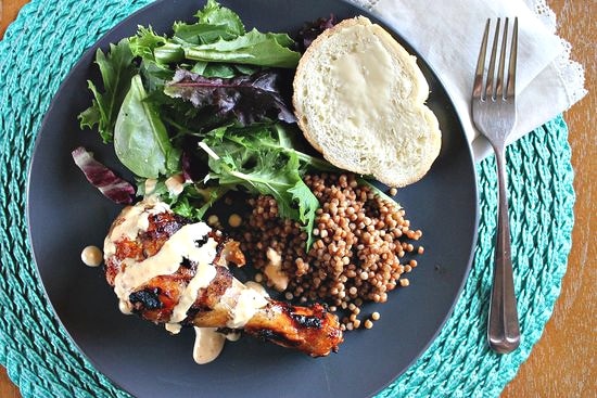 chipotle chicken mango drumsticks served with couscous and salad