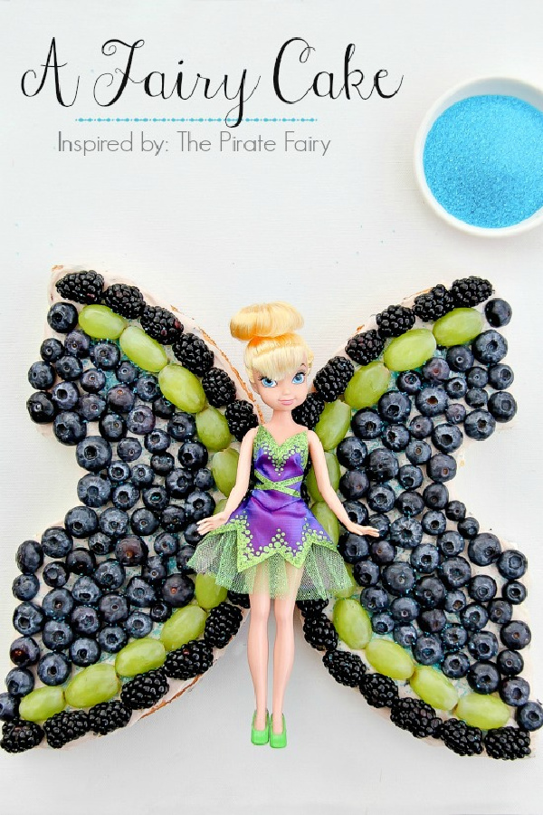 an angel food cake topped with fruit that looks like fairy wings