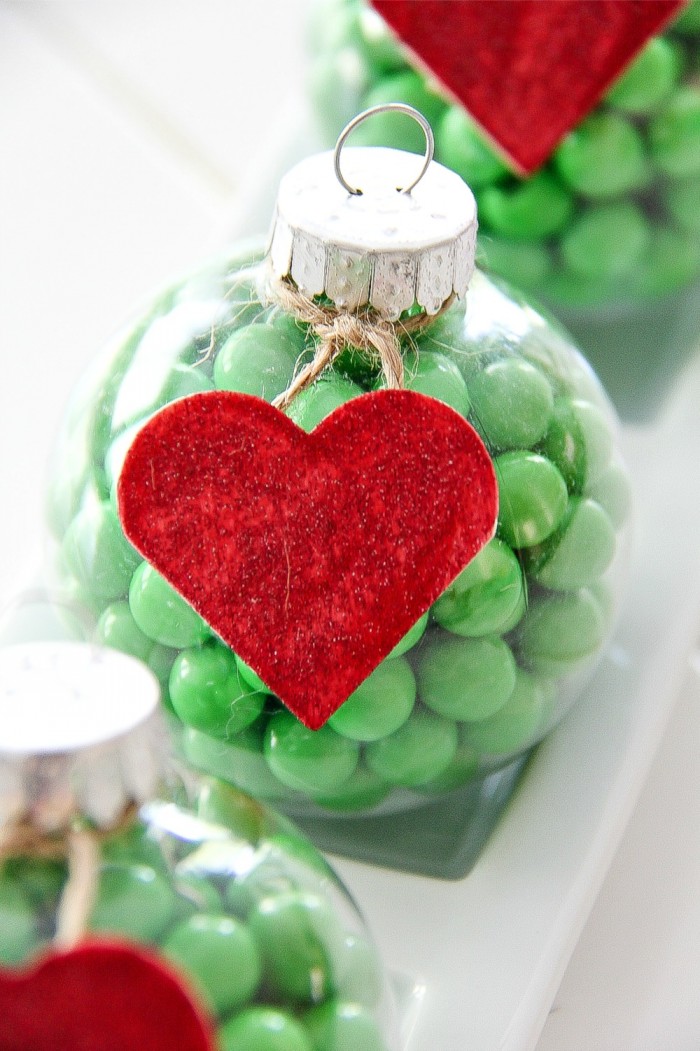 ornaments with a red heart and green candy inspired by the grinch