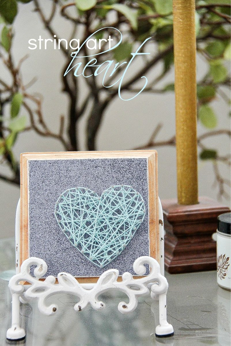 small string art heart on silver paper and wood