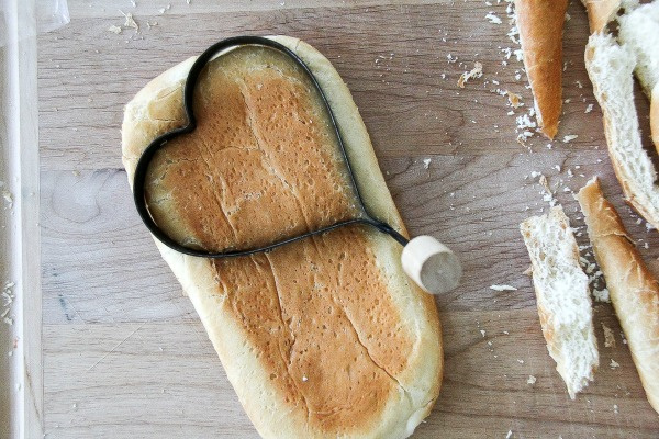 a heart shaped cookie cutter on bread