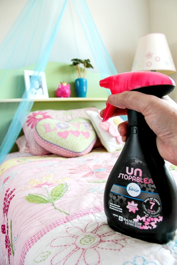 spray bottle of unstoppables refreshing a kids bedroom