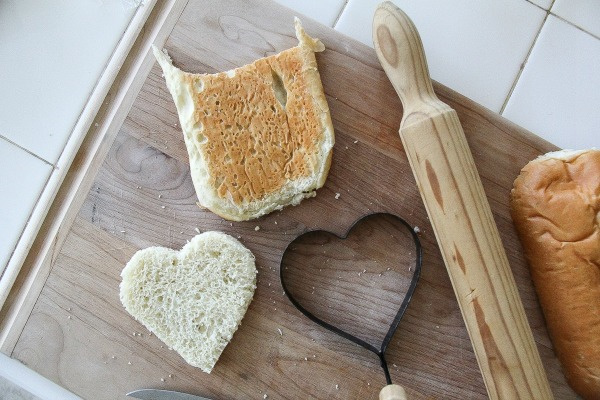 bread cut into a heart shape on a cutting board