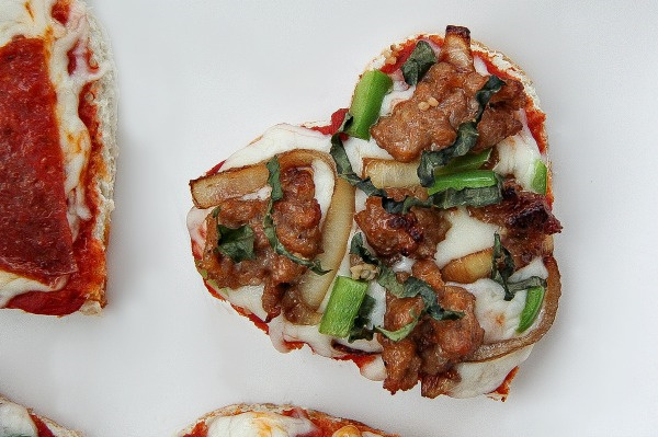 heart shaped sausage and basil pizza with caramelized onions