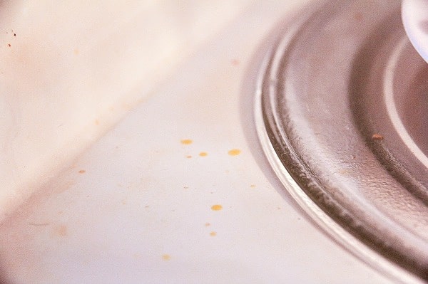 inside a microwave with food splatters