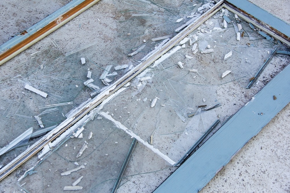 glass smashed out of a blue window frame