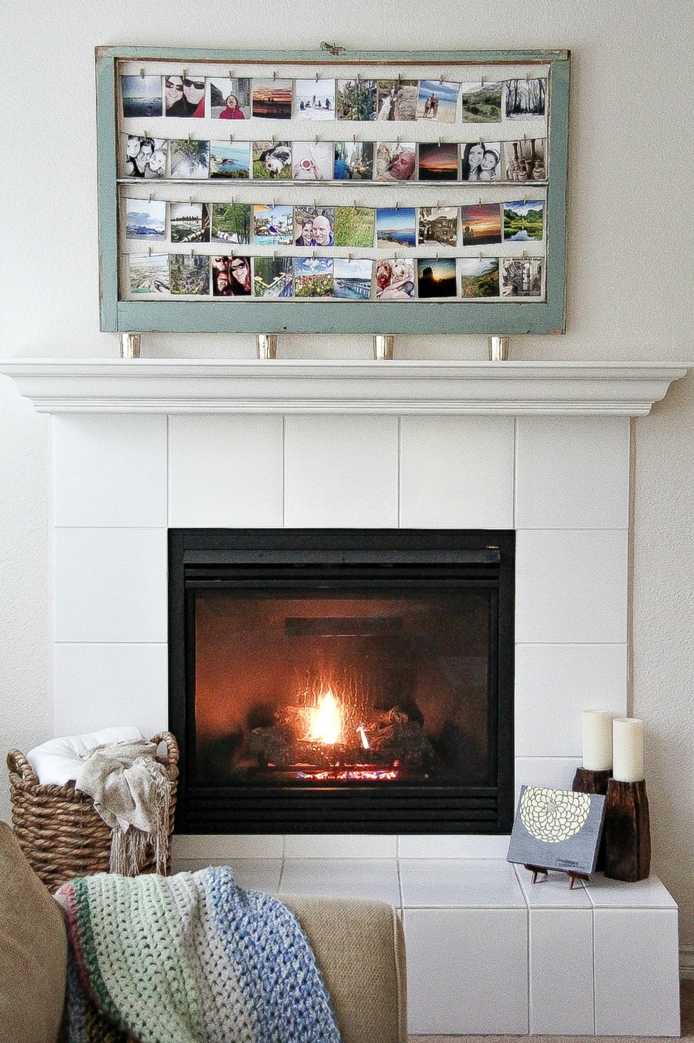 a blue frame containing square photos hanging over a fireplace