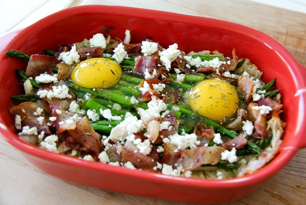 eggs, asparagus, hash browns, and bacon in a casserole dish