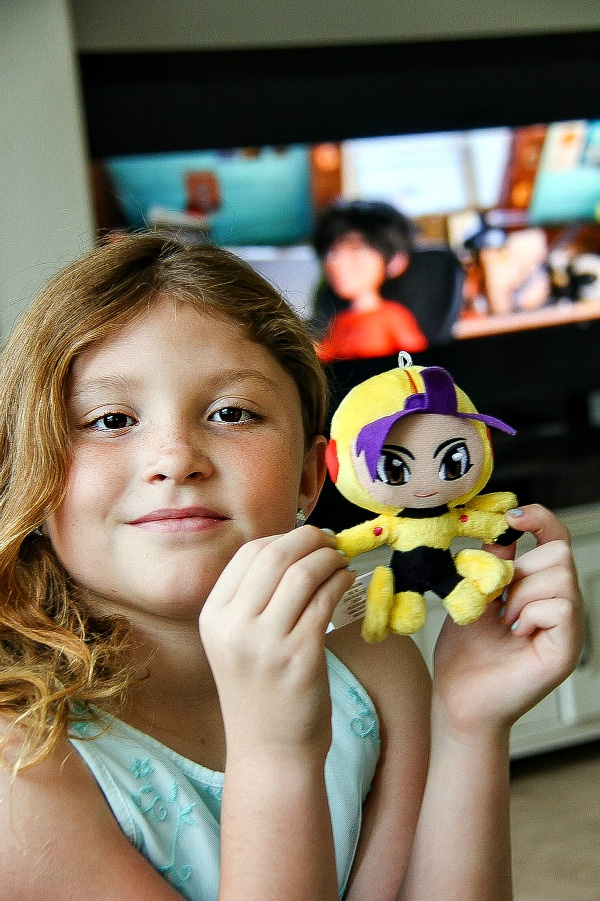 girl holding a big hero 6 plush doll