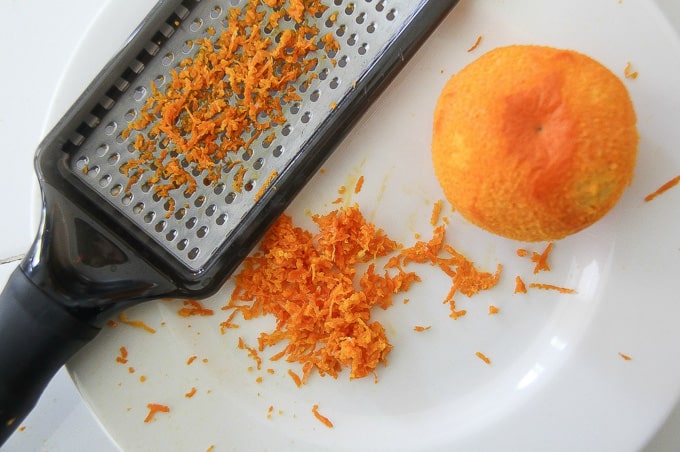 mandarin zest being grated off a halos mandarin