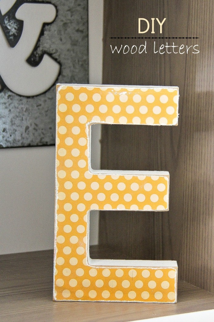 a wood letter with scrapbook paper over the top