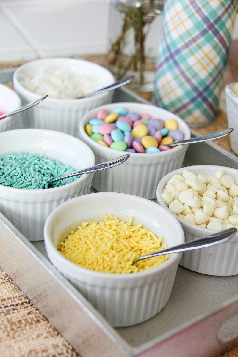 pastel candies and toppings in white bowls