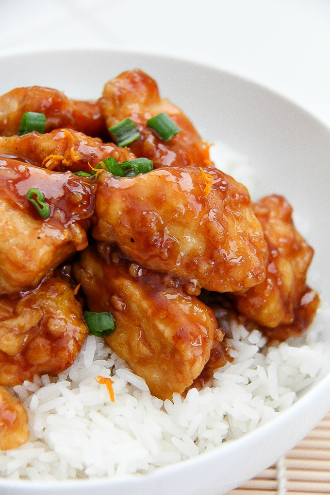 mandarin chicken with rice in a white bowl