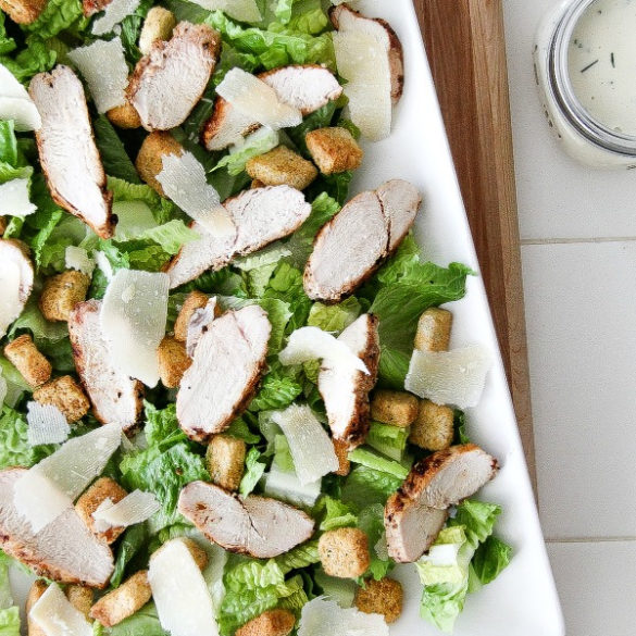 grilled chicken salad on a white serving tray