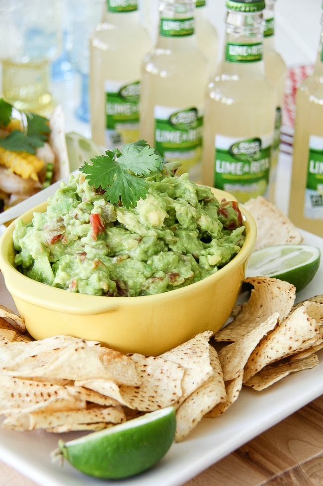 guacamole in a yellow bowl with corn chips