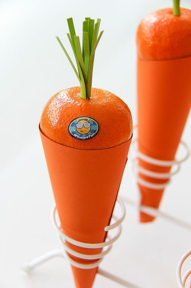 halos mandarins sitting on an orange paper cone to look like a carrot
