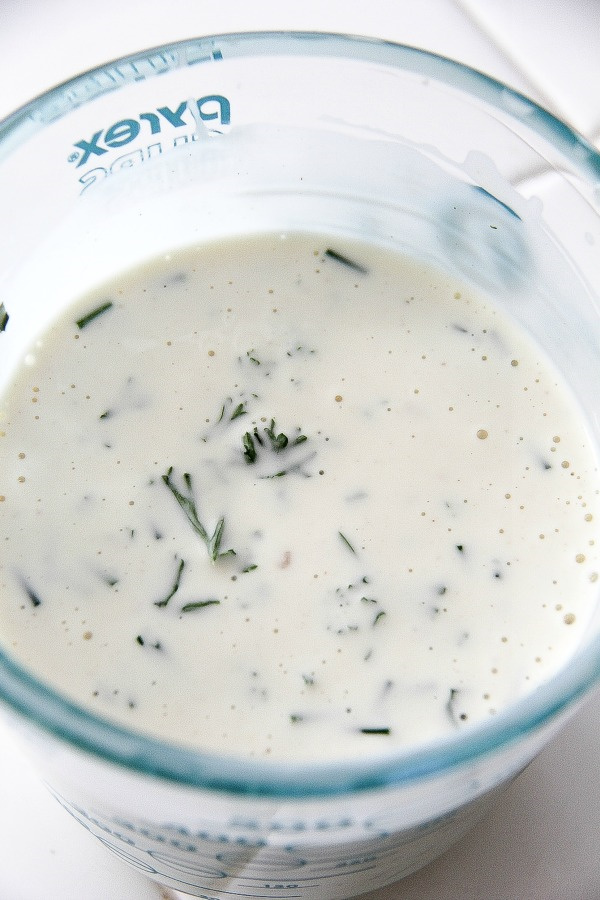 homemade caesar salad dressing in a glass jug