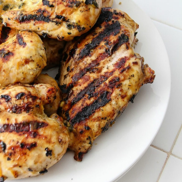 grilled chicken breasts on a white plate