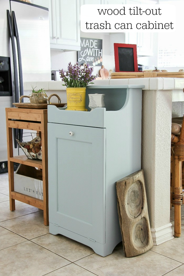 grey wood trash can cabinet in a kitchen