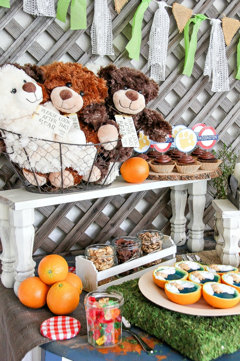 teddy bear party table with snacks and stuffed bears