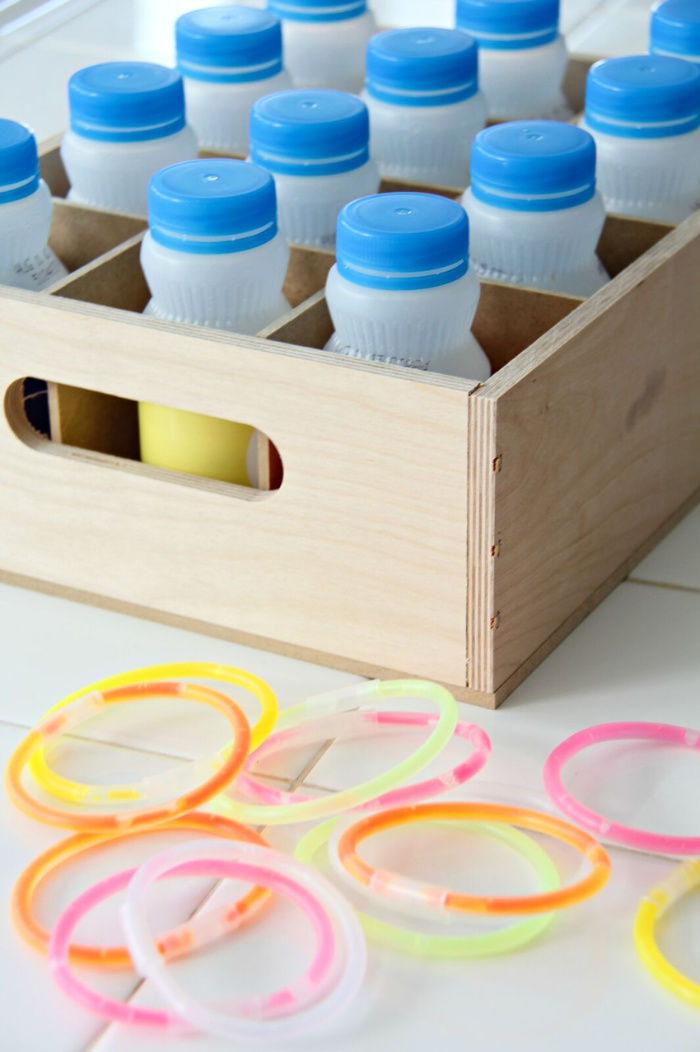 SunnyD bottles inside a wood crate for a ring toss game