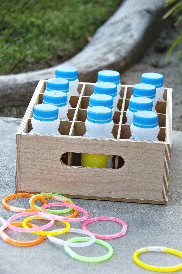 a ring toss game made out of drink bottles and old glow in the dark bracelets