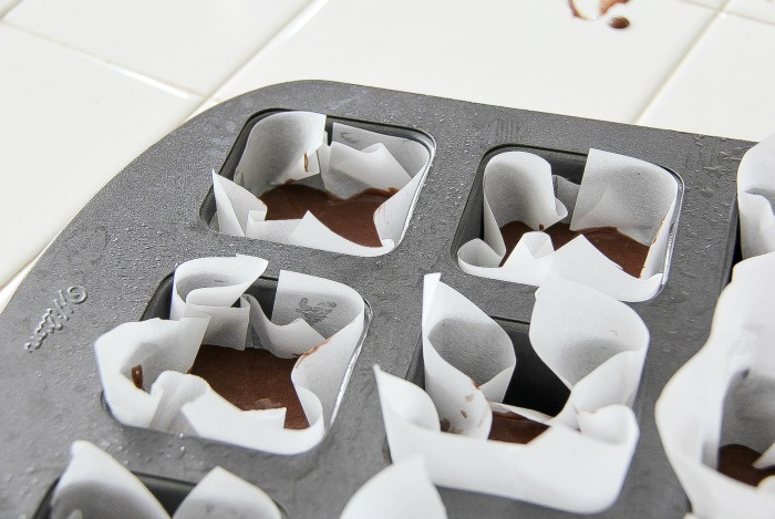 cake cooking in individual brownie pan with parchment paper