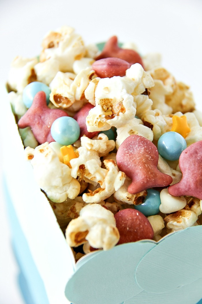 snack mix for kids for an under the sea party with pink goldfish, popcorn and blue bubble candy