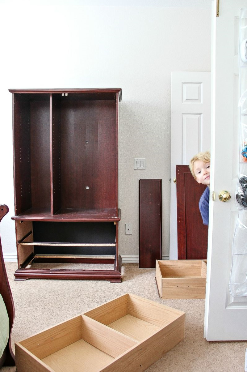 a wood armoire with the doors and drawers pulled off for restoring