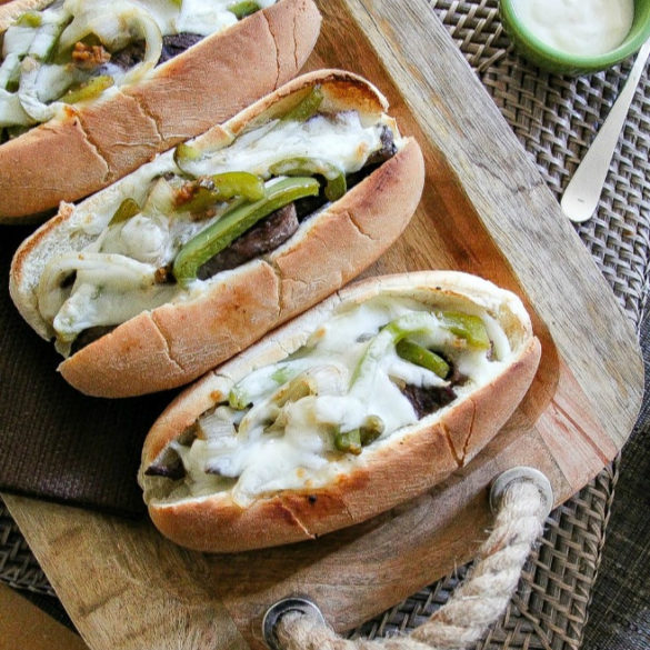 philly cheesesteak sandwich on a wood tray