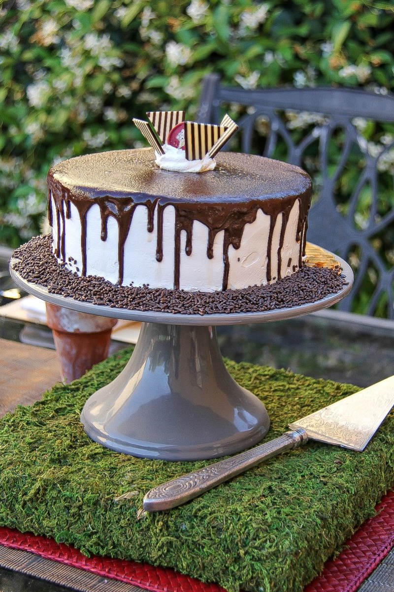 an icecream cake on a cake stand on top of a moss block