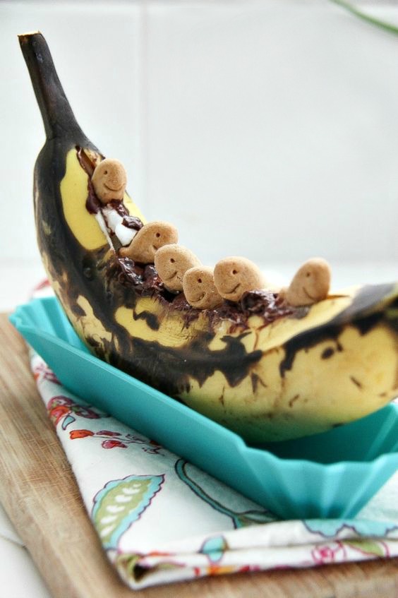 grilled banana filled with chocolate chips, marshmallows, and goldfish honey grahams