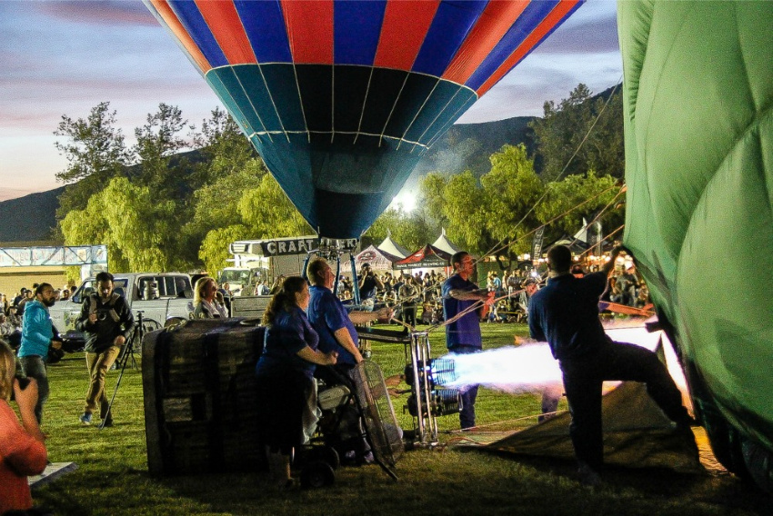 hot air balloons being inflated at a festival