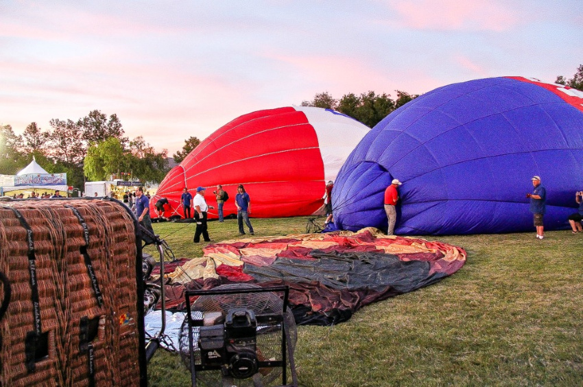 hot air balloons on the ground waiting to be inflated