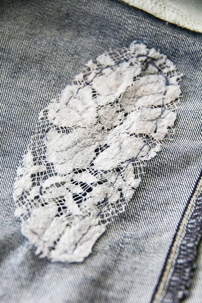 a lace patch over a hole in jeans