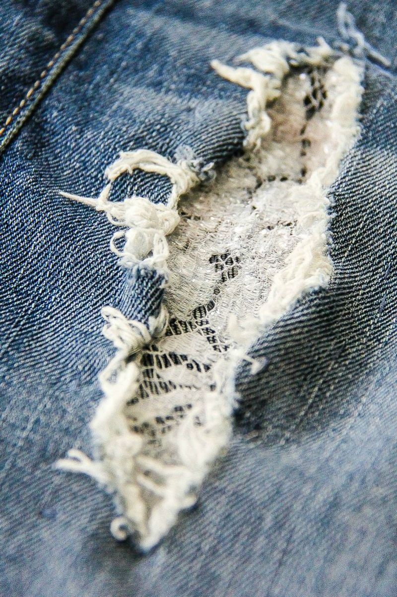 a lace patch inside a jeans hole