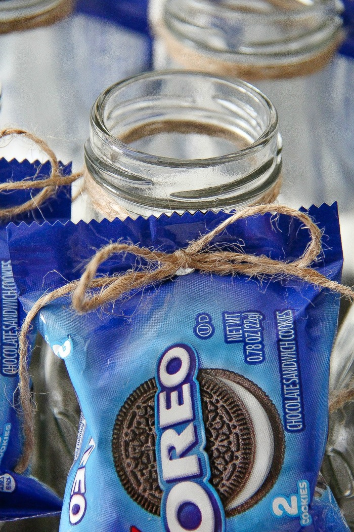 hole punched in oreo bag of cookies and tied to a milk bottle with string