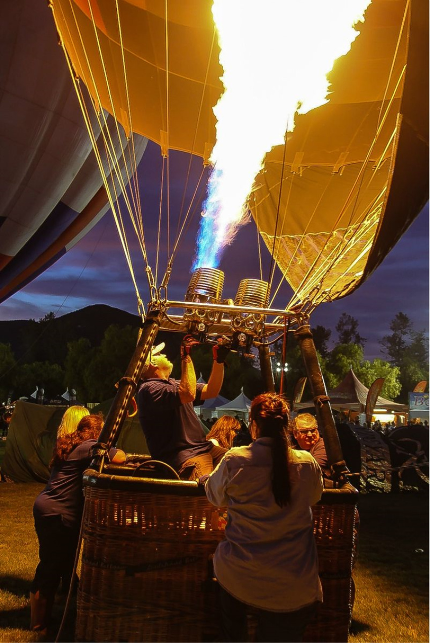 people inside a hot air balloon basket after dark