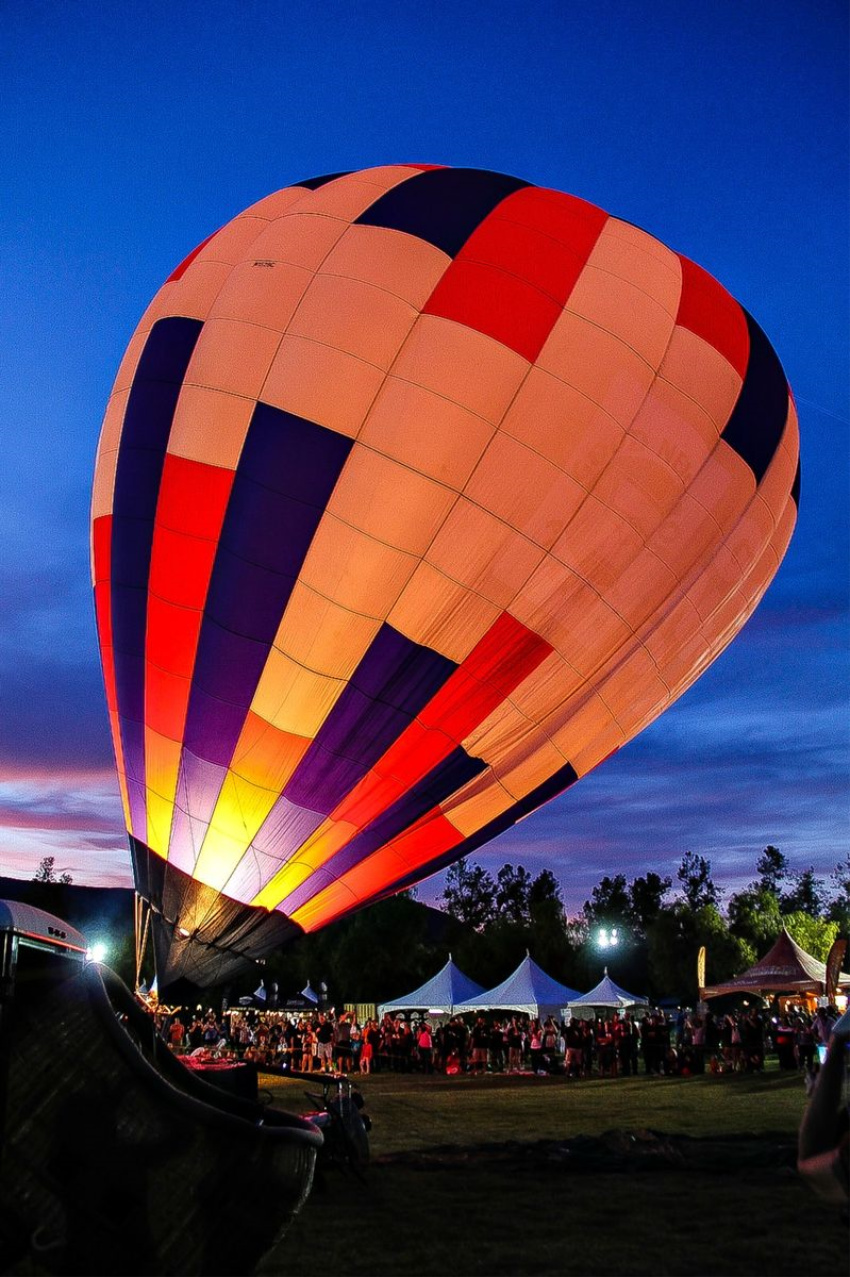 a hot air balloon on the ground being inflated