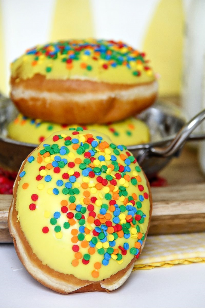 doughnuts with yellow frosting and colorful sprinkles