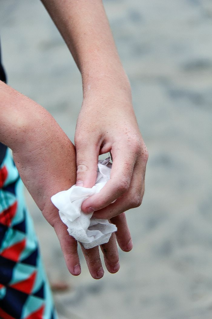 boy using wipes on his hands