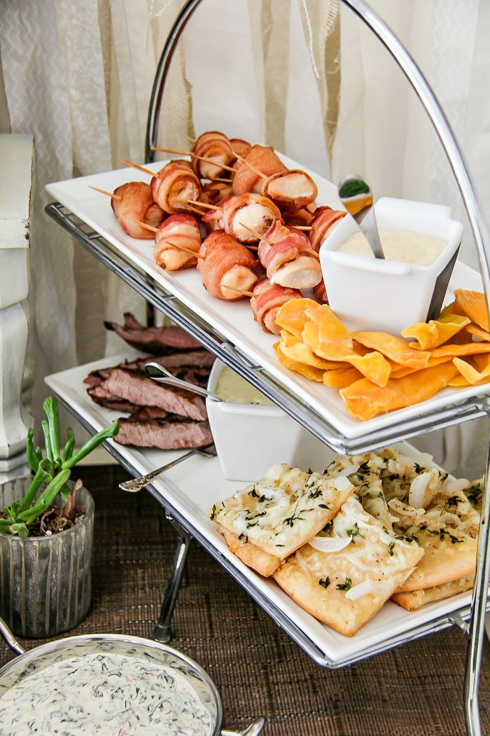 party appetizer tiered trays with bacon, beef, pizza, and dried fruit