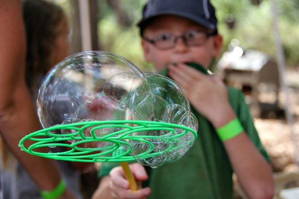 boy using a plastic bubble maker