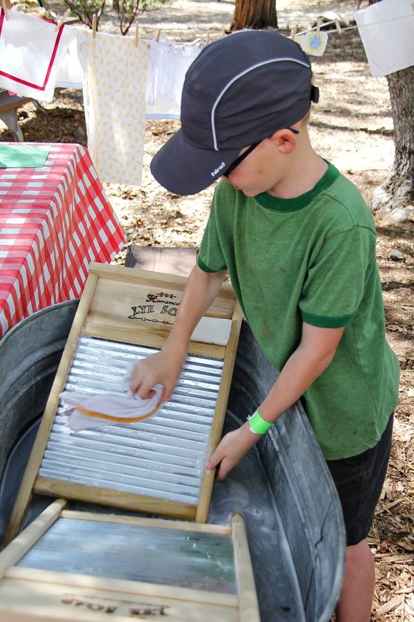 boy washing a cloth on a board