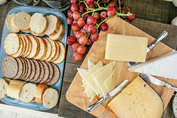 cheese board and crackers with red grapes