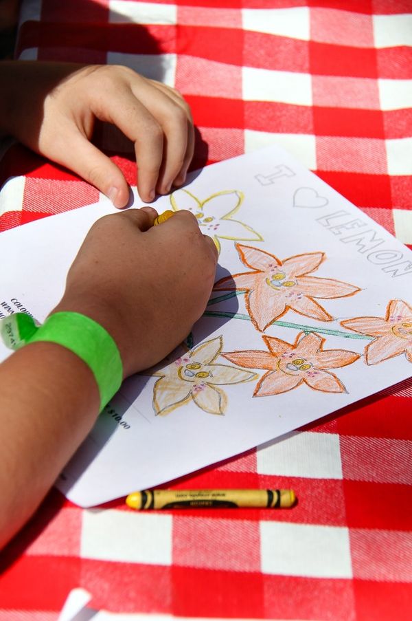 girl coloring in flowers on a coloring page