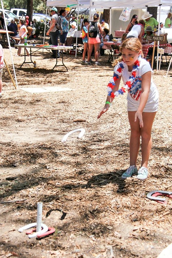 girl throwing horseshoes