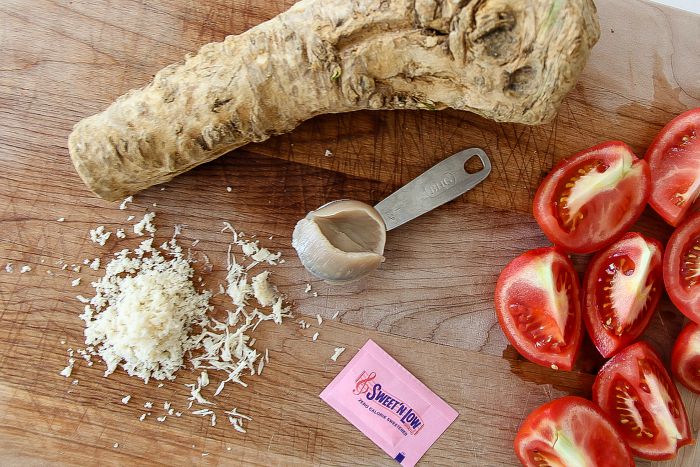 ginger, tomatoes, and bacon fat on a cutting board